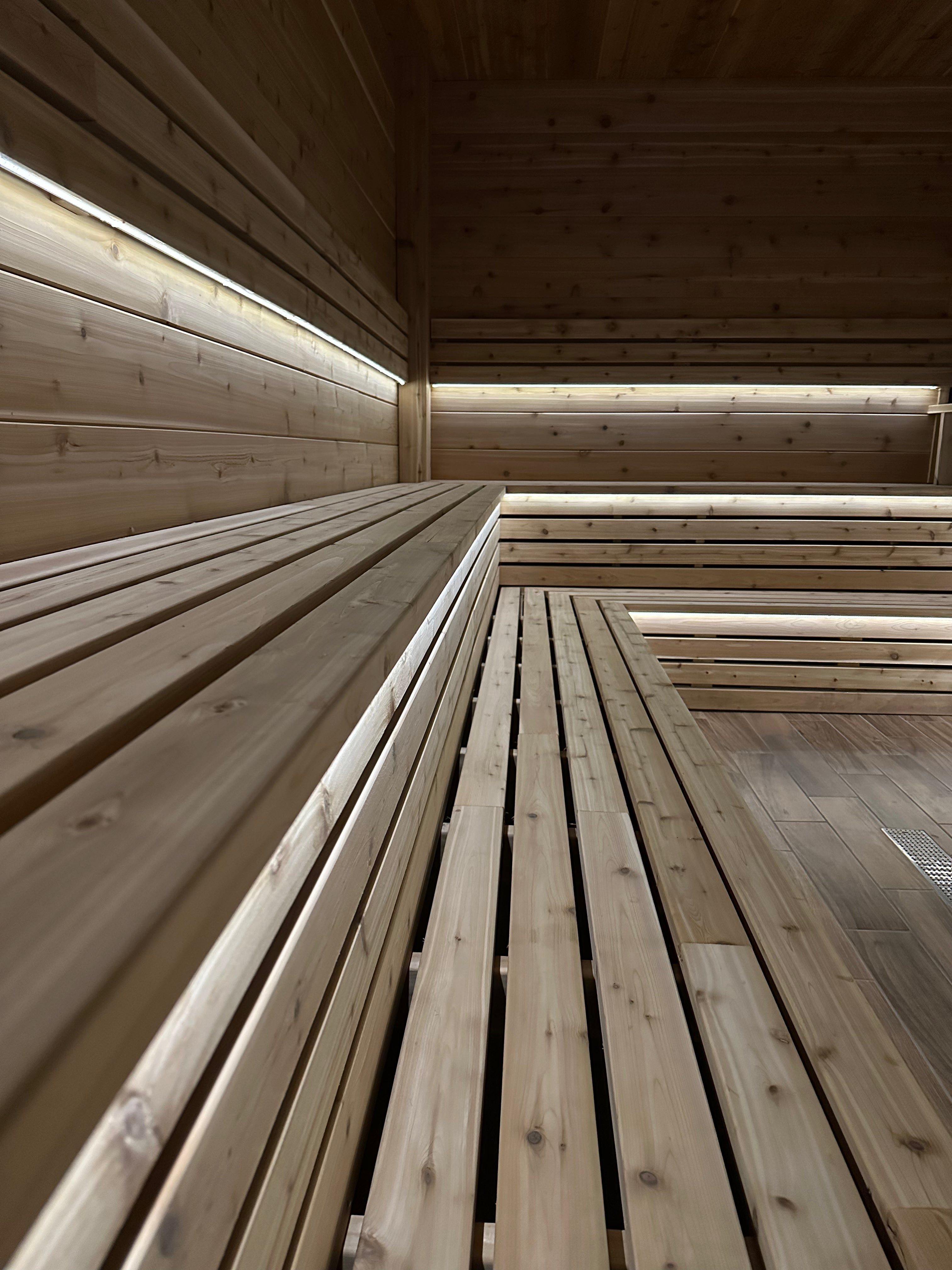 Custom wooden sauna interior with benches.